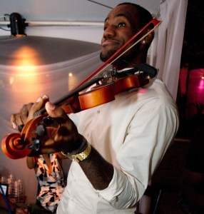 LeBron and Chris playing violin and singing.